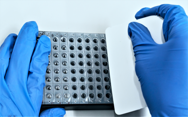 Lidding a microplate with a pressure sensitive tape